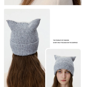 Detailed close-up of grey wool-blend knit beanie with cute 3D cat ear decorations