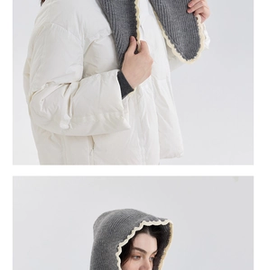Detail of gray knitted hooded scarf featuring delicate cream scalloped lace trim details