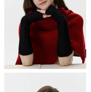 Detailed texture of black knit fingerless arm warmers on model for winter styling