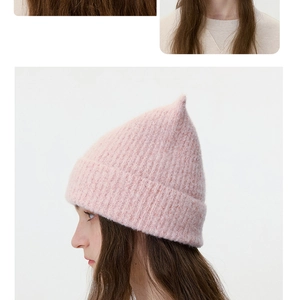Detail of light pink wool blend beanie featuring a soft mohair texture and pointed top