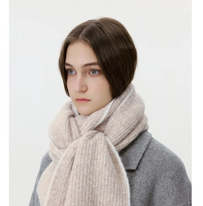 Close-up of beige knit scarf texture and thick wool blend material for winter warmth