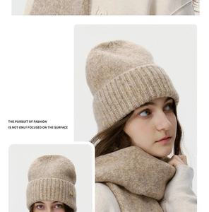 Detailed close-up showing thick oatmeal wool knit texture of beanie and matching scarf set