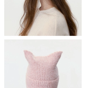 Detailed view of pink knitted beanie featuring cute cat ears and soft ribbed texture