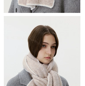 Close-up of soft beige knit wool scarf texture paired with a grey winter wool coat