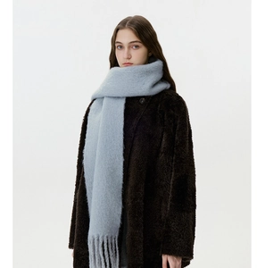 Close-up of soft light grey wool blend scarf showing fuzzy texture and thick tassels