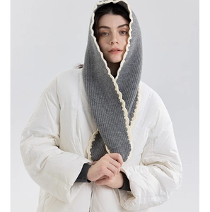 Detail of grey ribbed knit hooded scarf with cream scalloped edges for autumn and winter