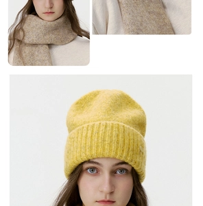 Close-up of bright yellow chunky knit beanie and oatmeal knitted scarf winter set