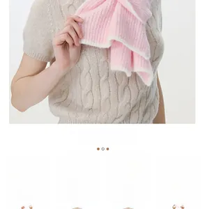 Detailed macro view of soft pink wool blend knit scarf with vertical ribbed texture