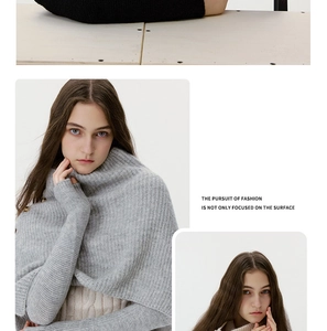 Detail of light grey ribbed knit cowl neck sweater featuring decorative side buttons