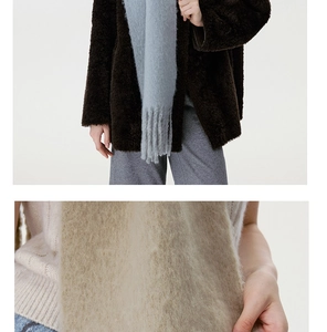Detail of wool blend scarf featuring soft plush texture and elegant tassel trim
