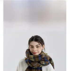 Close-up of thick plaid scarf featuring blue, ginger, and brown soft mohair-like texture
