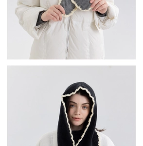Detail of dark knit balaclava with white ruffled edges and warm drawstring design