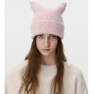 Close-up of pink knit beanie showing ribbed texture and cute cat ear design details