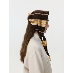 Striped knit headscarf in dark brown with colorful stripes worn by a fashion model