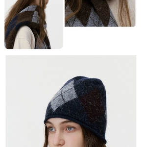 Close-up of thick argyle knit beanie and scarf set in grey and navy blue for winter