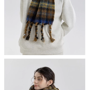 Macro shot of fluffy mixed color plaid scarf with thick woven tassels for autumn and winter