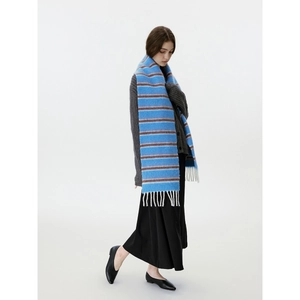 Blue and brown striped wool blend scarf with white tassels on a studio model