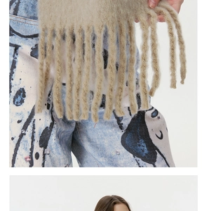 Close-up of beige wool blend scarf with thick tassels and premium fuzzy texture detail