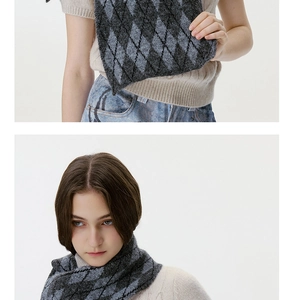 Detail of grey and black argyle knit scarf showing thick texture and winter styling