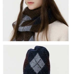 Detail view of the fuzzy argyle knit beanie and matching scarf in brown and navy blue colors