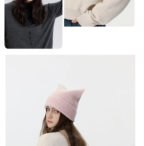 Detail of pink cat ear knit hat showing thick wool texture and soft knitted pattern