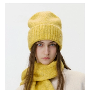 Detail of yellow ribbed knit beanie and matching scarf set with thick warm texture