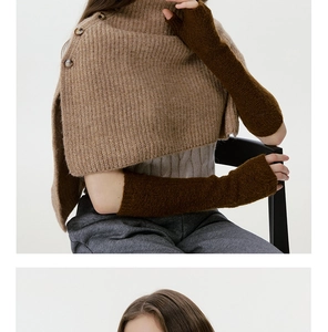 Detail of soft knit shawl with shoulder buttons and long fingerless gloves in camel brown
