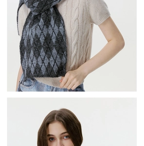 Detail view of the gray argyle knit scarf texture and pattern on a casual outfit