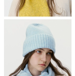 Detail of light blue knitted beanie and scarf set featuring soft mohair texture