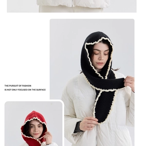 Detail of knitted balaclava hood with contrast wavy edges in black and red style