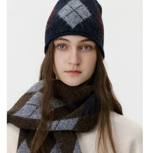 Detail of blue diamond pattern knit beanie and scarf set with soft wool texture