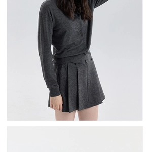 Detail showing high-quality dark grey knitted wool blend cardigan and pleated skirt set