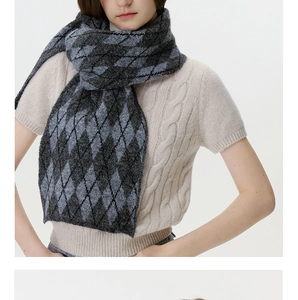Close-up of winter knit scarf featuring classic grey argyle diamond pattern and soft texture
