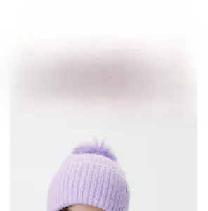 Detail of purple knit beanie with fur pom-pom showing size and weight measurement specs