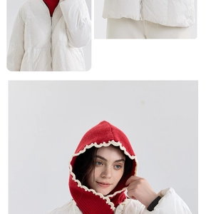 Detail of red knit hood with cream wavy trim paired with a white puffer jacket