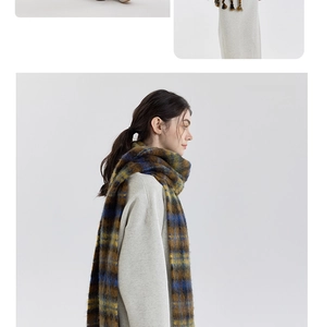 Close-up of the fluffy brushed texture and retro plaid pattern on a soft winter scarf