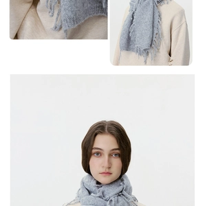 Close-up of light grey wool blend knit scarf with long decorative fringe tassels
