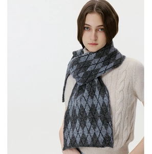 Detail of Argyle knit scarf showing textured grey diamond pattern and thick wool fabric