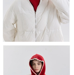 Detail of white quilted windproof jacket with red knitted hooded neck and zipper