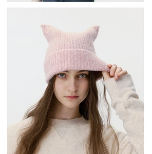 Detailed close-up of pink knit cat ear beanie featuring soft wool blend ribbed texture