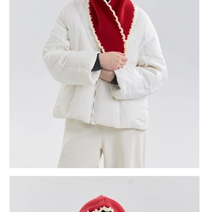 Detail of red ribbed knit scarf with cream ruffle trim and thick wool texture