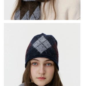 Detail of argyle knit beanie and scarf set featuring navy, grey and brown warm textures