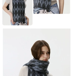 Detail view of winter knit scarf featuring black and grey argyle diamond patterns