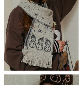 Detailed knit texture of snowman patterned scarf and hat with thick fringe accents