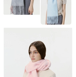 Detail view of knitted tassel scarves in pink, blue, and gray colors for winter warmth