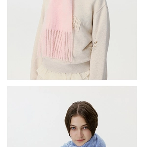 Close-up of high-weight plush scarves featuring tassel details and soft knitted texture