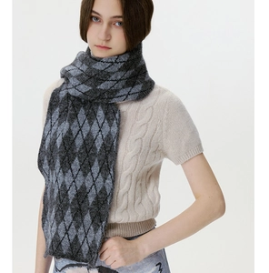 Detail of classic black and grey argyle knit pattern on a warm winter scarf