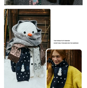 Detail of wool blend knitted scarf featuring cartoon snowman jacquard and fringe edges