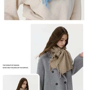 Detailed view of thick knit wool blend scarves featuring fringe trim in blue and camel
