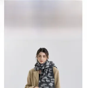 Macro shot of thick grey knit scarf with marble texture styled with a beige wool coat